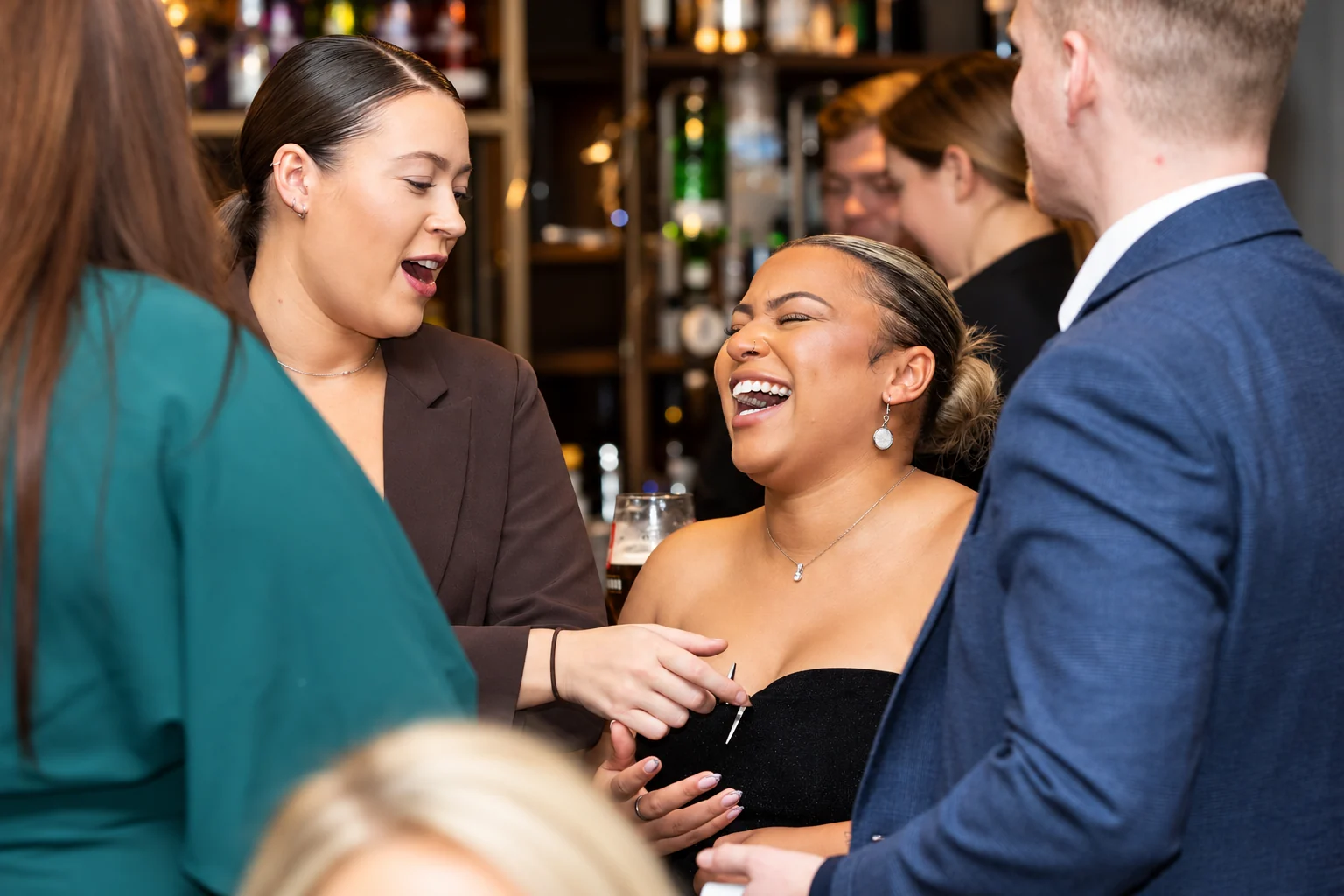 Guests laughing and reacting as Ben performs close-up magic at an event